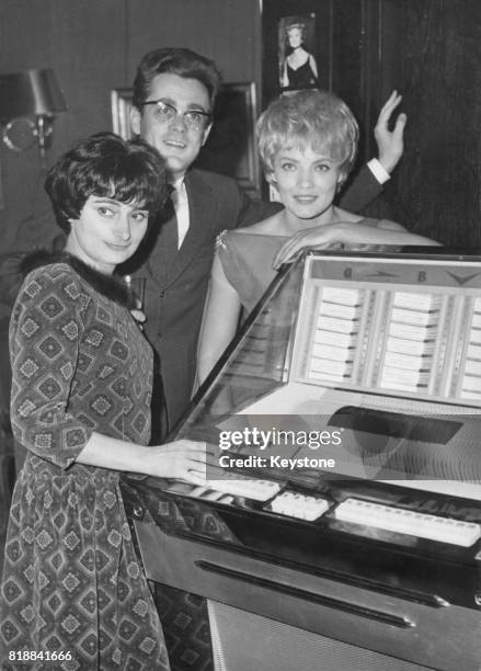 From left to right, actors Agnes Varda, Michel Legrand and Corinne Marchand at a reception at the Club Saint-Hilaire in Paris to mark the completion...