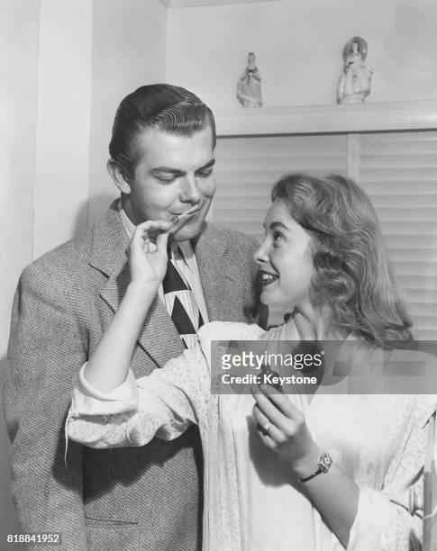 American actress Janet Leigh tests perfume on her husband Stanley Reames, circa 1945.