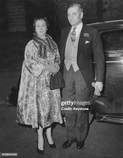 British actress Vivien Leigh and her husband, actor Laurence Olivier, arrive at Holy Trinity Church in London for the wedding of Miss Leigh's...