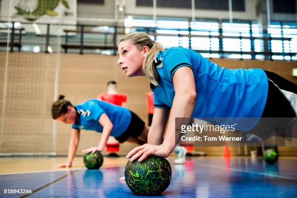 female handball players warming up with push-ups - handball stock pictures, royalty-free photos & images