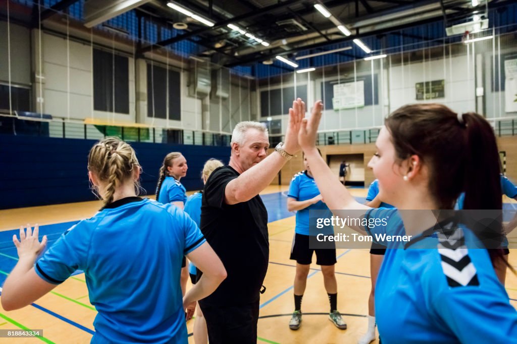 Handball player with trainer