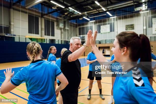 handball player with trainer - sports team high five stock pictures, royalty-free photos & images