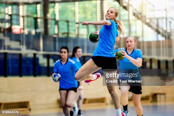 female handball player throwing ball - handball stock pictures, royalty-free photos & images