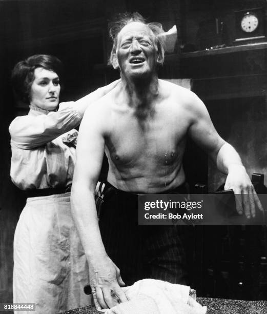 Actress Christine Hargreaves as Nellie Lambert, washing the back of John Barrett as Lambert, during rehearsals for the play 'A Collier's Friday...