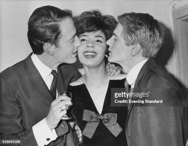 From left to right, composer John Barry, and singers Shirley Bassey and Adam Faith at one of Faith's parties, London, UK, January 1961.