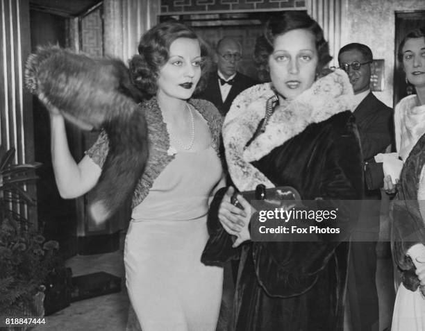 American actress Tallulah Bankhead with a friend at the premiere of the film 'The Private Life of Don Juan' at the New London Pavilion, 6th September...