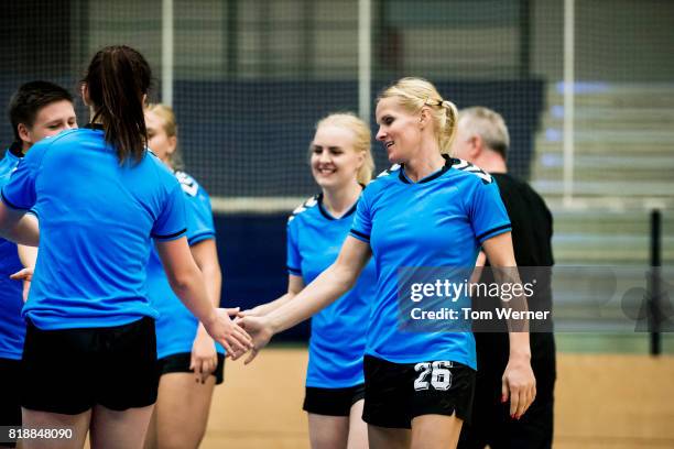 shaking hands after the match - team handball stock-fotos und bilder