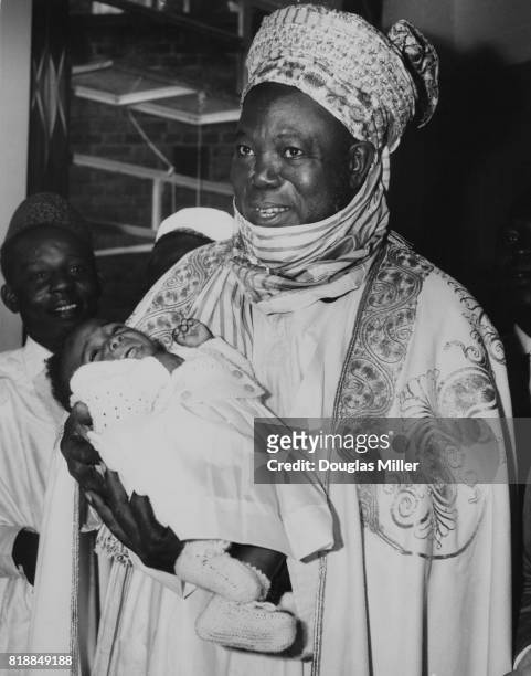Ahmadu Bello , the premier of Northern Nigeria, holding 8-month-old Siamese twin Joan Adamu at Hammersmith Hospital in London, 19th July 1962. Joan,...