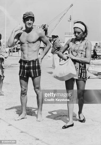 French actor Jean-Paul Belmondo and his wife Élodie on holiday on the Cote d'Azur in France, 14th August 1965.