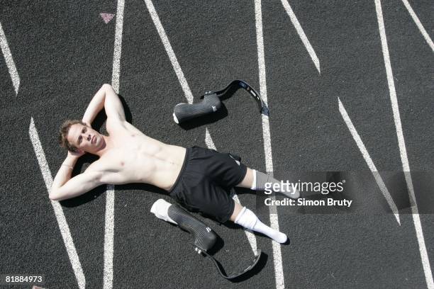 Track & Field: Aerial portrait of South Africa Oscar Pistorius lying on track with Hanger Orthopedic Group prosthetic legs, handicapped,...