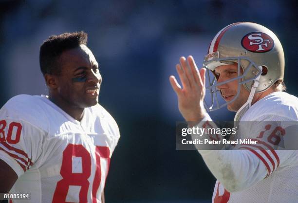 Football: Closeup of San Francisco 49ers Jerry Rice and QB Joe Montana on sidelines during game vs Cincinnati Bengals, Cincinnati, OH 12/9/1990