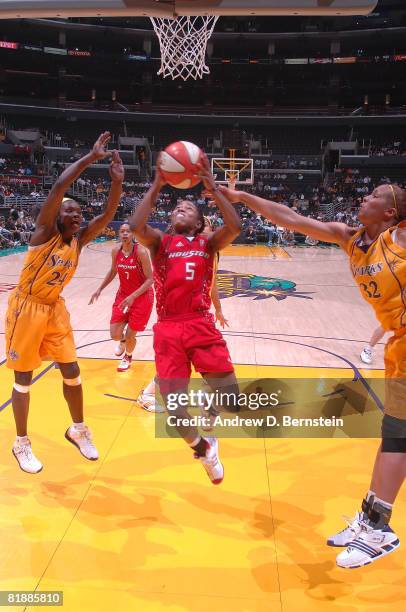 Marie Ferdinand-Harris and Christi Thomas of the Los Angeles Sparks attempts to block a shot from Erica White during of the Houston Comets during the...