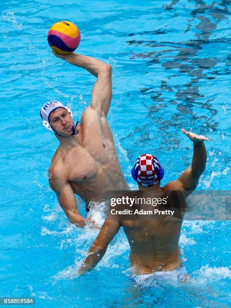 Ivan Nagaev of Russia shoots past Andelo Setka of Croatia during the Men's Water Polo, Group D preliminary match between Russia and Croatia on day...