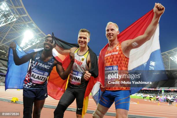 Bronze medalist Jean-Baptiste Alaize of France, gold medalist Markus Rehm of Germany and silver medalist Ronald Hertog of the Netherlands pose for...