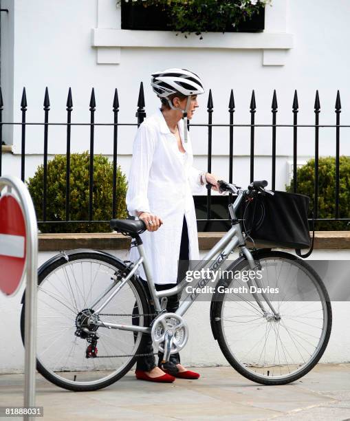 Presenter Anne Robinson pushes her bycycle as she leaves her home in Kensington, July 10, 2008 in London, England. Robinson has been banned from...