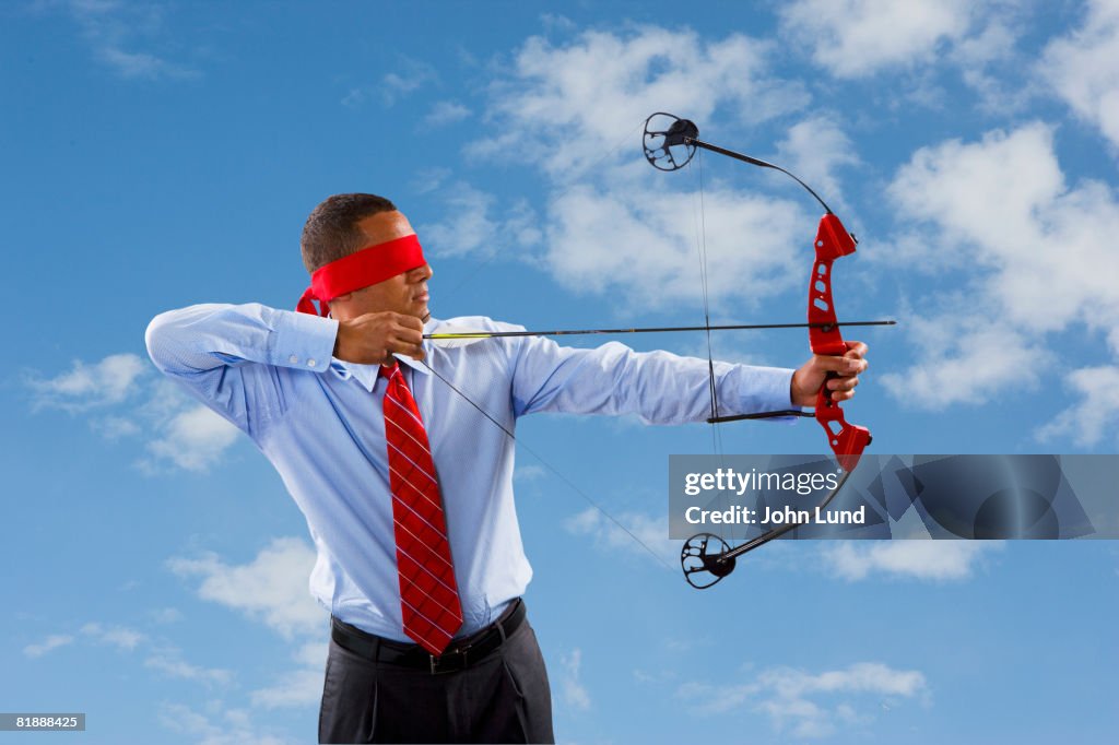 Business man Shooting Arrow