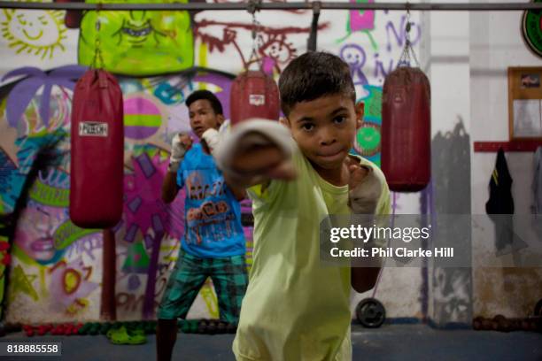 Children, young men training at Boxing school Instituto Todos Na Luta , set up by Raff Giglio in Vidigal. Since pacification in 2011, Vidigal has...