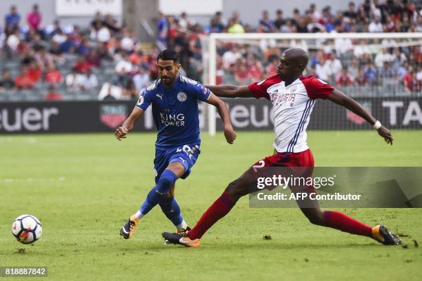 Leicester City's Algerian midfielder Riyad Mahrez challenges West Bromwich Albion's Cameroonian defender Allan Nyom during the 2017 Premier League...