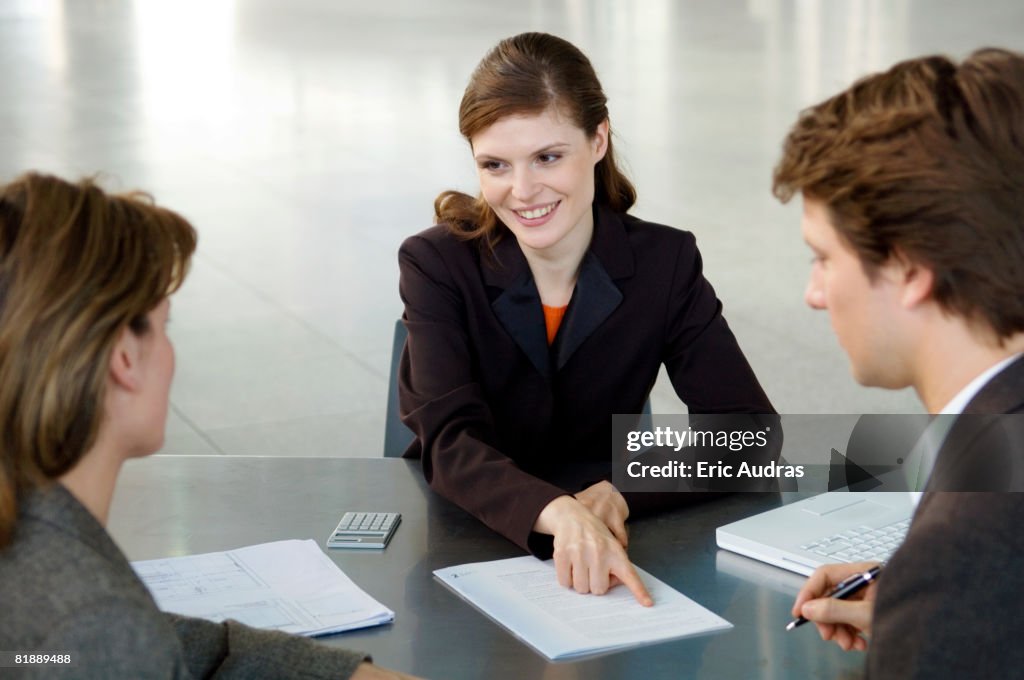 Real estate agent explaining a contract to a couple
