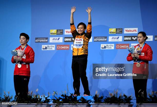 Silver medalist Yajie Si of China, gold medalist Jun Hoong Cheong of Malaysia and bronze medalist Qian Ren of China pose with the medals won during...
