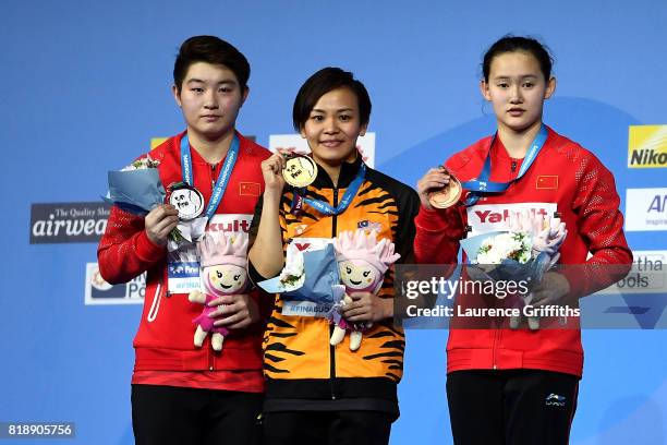 Silver medalist Yajie Si of China, gold medalist Jun Hoong Cheong of Malaysia and bronze medalist Qian Ren of China pose with the medals won during...