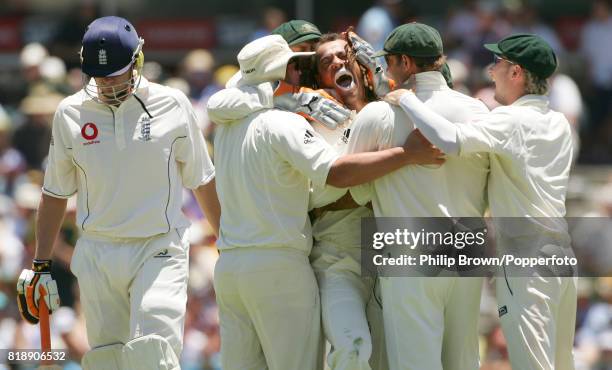 Andrew Symonds of Australia is surrounded by team-mates after getting the wicket of England captain Andrew Flintoff for 13 runs in the 3rd Test match...