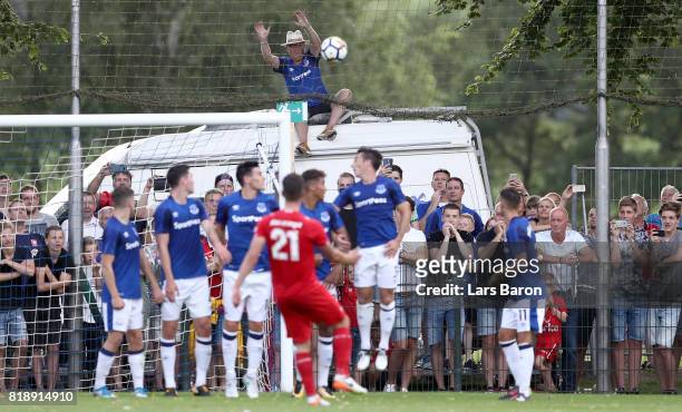 Fan of Everton sits on a car and tries to catch a free kick of Danny Holla of Twente during a preseason friendly match between FC Twente and Everton...