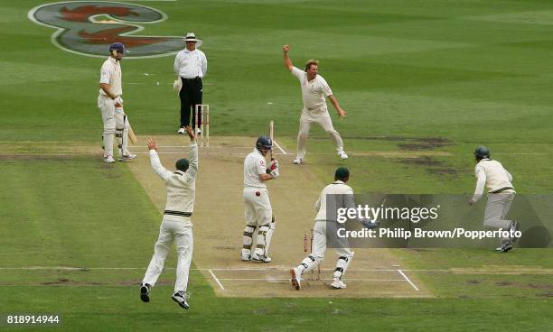 Shane Warne of Australia celebrates bowling England batsman Andrew Strauss to reach 700 Test wickets during the 4th Test match between Australia and...