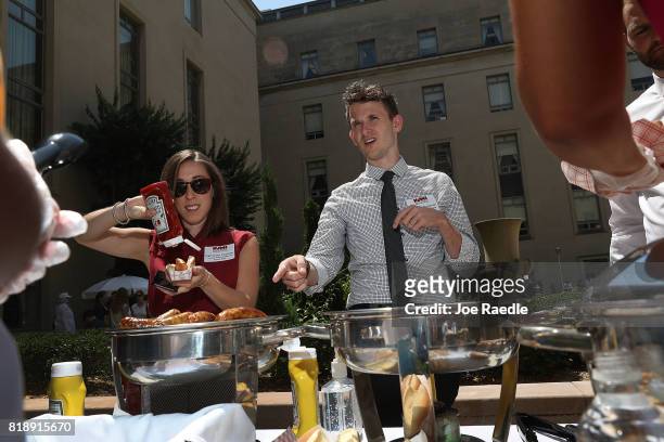 Katharine Cooksey, from Texas, and Roman Burleson, from Missouri, enjoy the hot dogs during the American Meat Institute's annual Hot Dog Lunch in the...