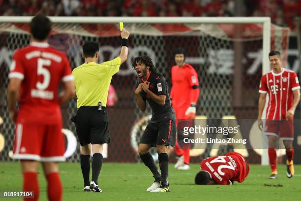 The referee produces a yellow card to Mohamed Elneny of Arsenal during the 2017 International Champions Cup football match between FC Bayern and...