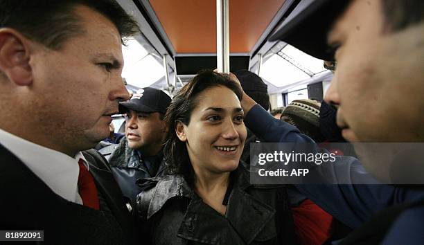 Chilean pole dancer Monserat Morilles is surrounded by Santiago's subway security personnel as she gets ready to perform on July 10, 2008 in...