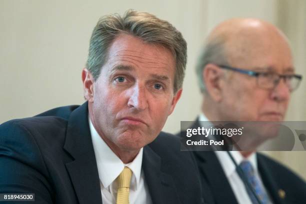 Sen. Jeff Flake and Sen. Pat Roberts attend a lunch with members of Congress hosted by US President Donald J. Trump in the State Dining Room of the...