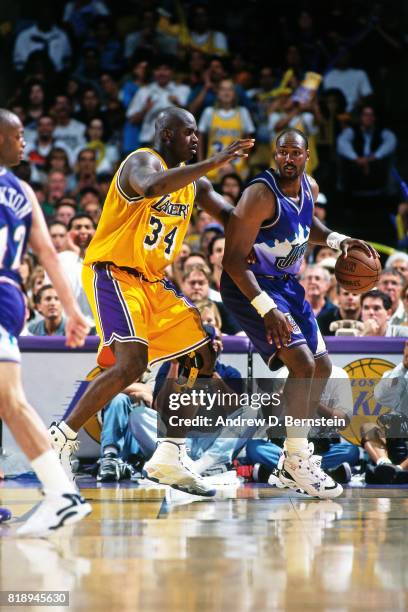 Karl Malone of the Utah Jazz dribbles against Shaquille O'Neal of the Los Angeles Lakers during Game Four of the Western Conference Playoffs at the...