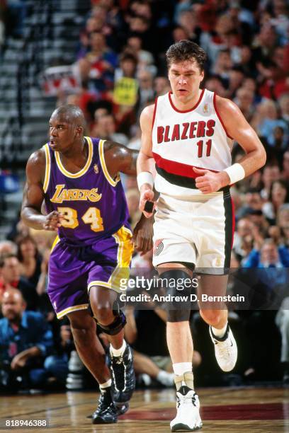 Arvydas Sabonis of the Portland Trail Blazers runs on the court against Shaquille O'Neal of the Los Angeles Lakers during Game Four of the Western...