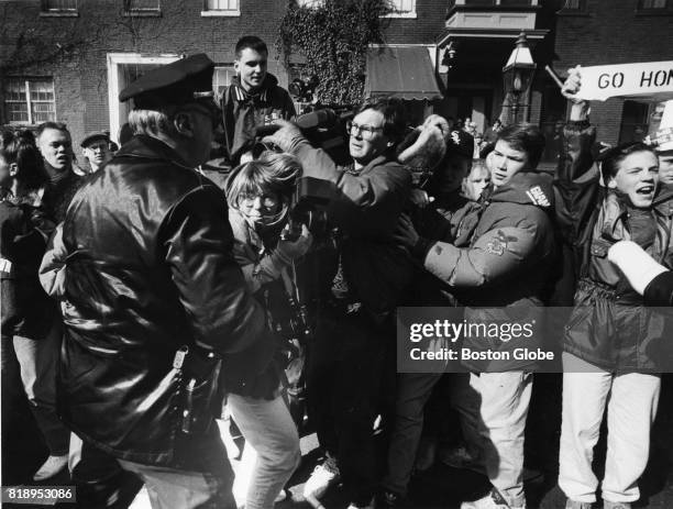 Boston Police push press and parade watchers to the side as a gay contingent marches by during the St. Patrick's Day Parade in South Boston, March...