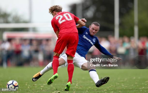 Jonatan Frimann of Twente is challenged by Wayne Rooney of Everton during a preseason friendly match between FC Twente and Everton FC at Sportpark de...