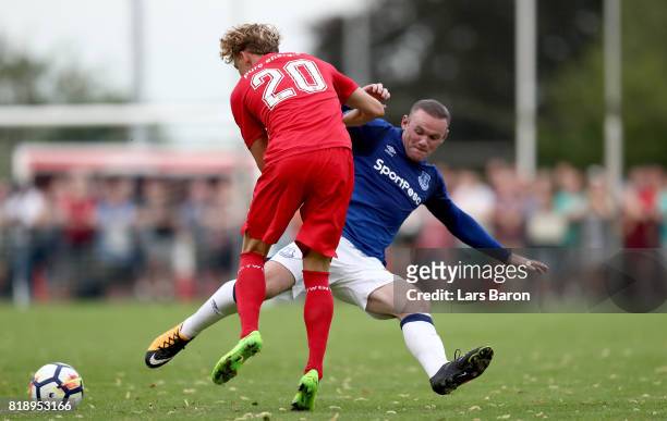 Jonatan Frimann of Twente is challenged by Wayne Rooney of Everton during a preseason friendly match between FC Twente and Everton FC at Sportpark de...