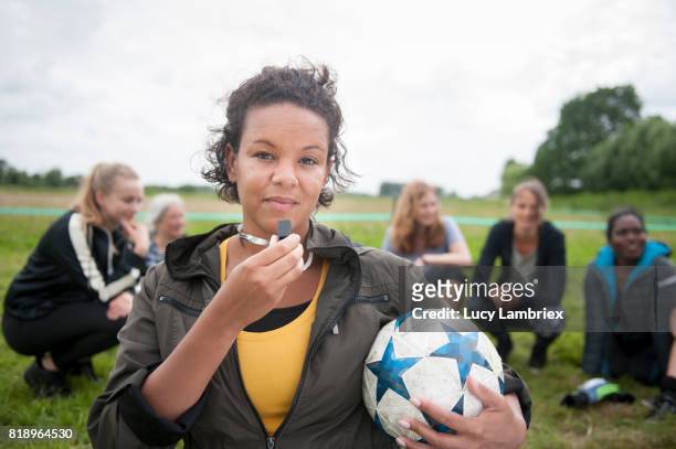 portrait of recreational female soccer player - female umpire stockfoto's en -beelden