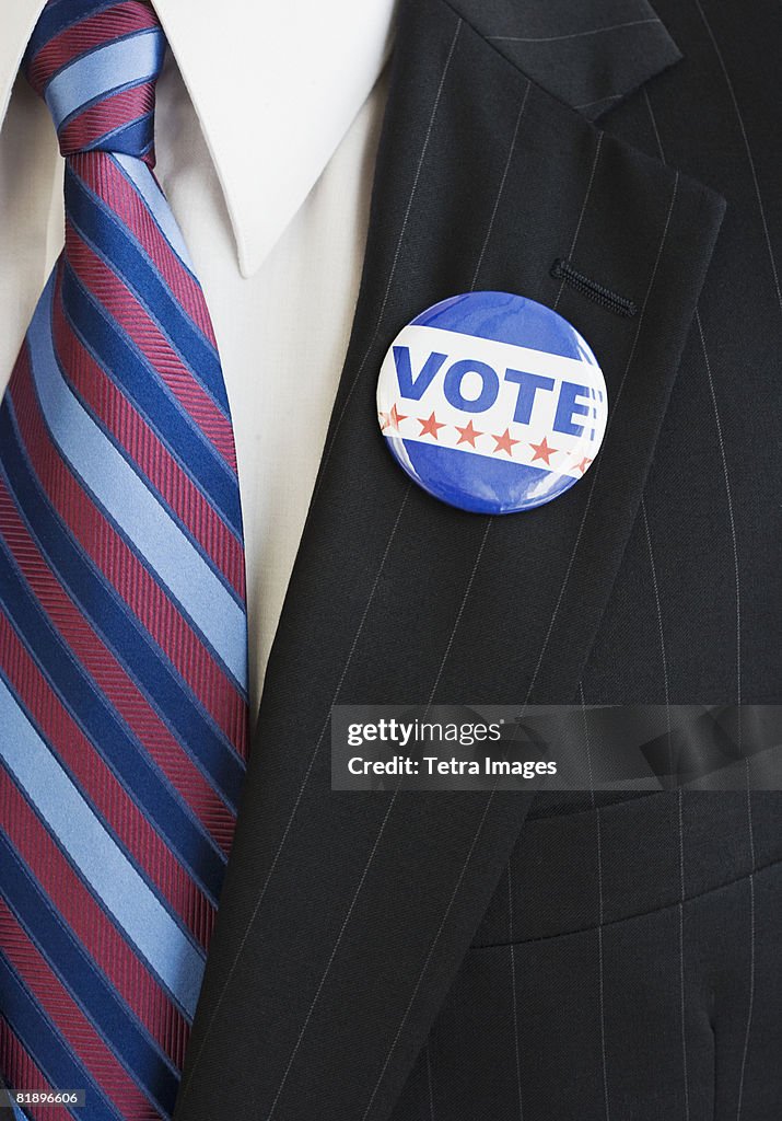 Vote pin on man?s lapel