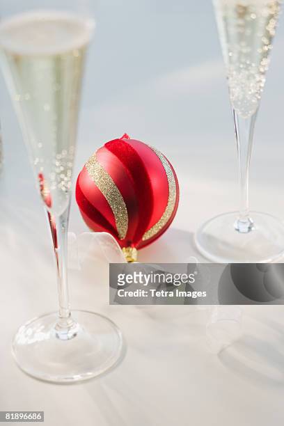 christmas ornament next to champagne glasses - champagne flute high angle stock pictures, royalty-free photos & images