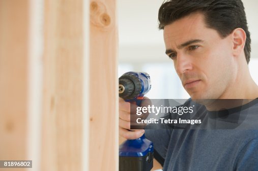 Man using cordless drill Man using cordless drill