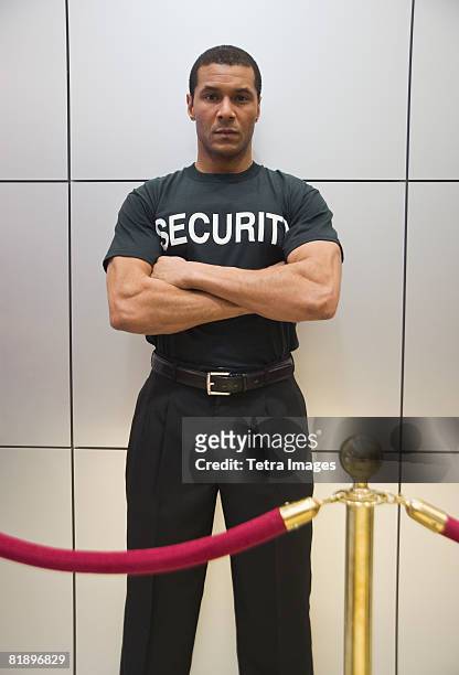 african male bouncer behind velvet rope - against the ropes world premiere stock pictures, royalty-free photos & images