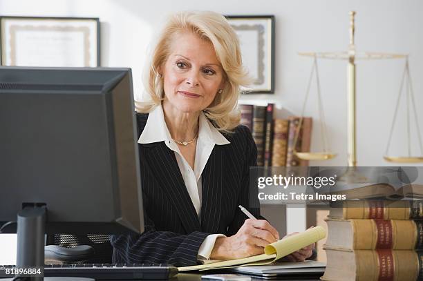 businesswoman writing on notepad - defence technology stock pictures, royalty-free photos & images