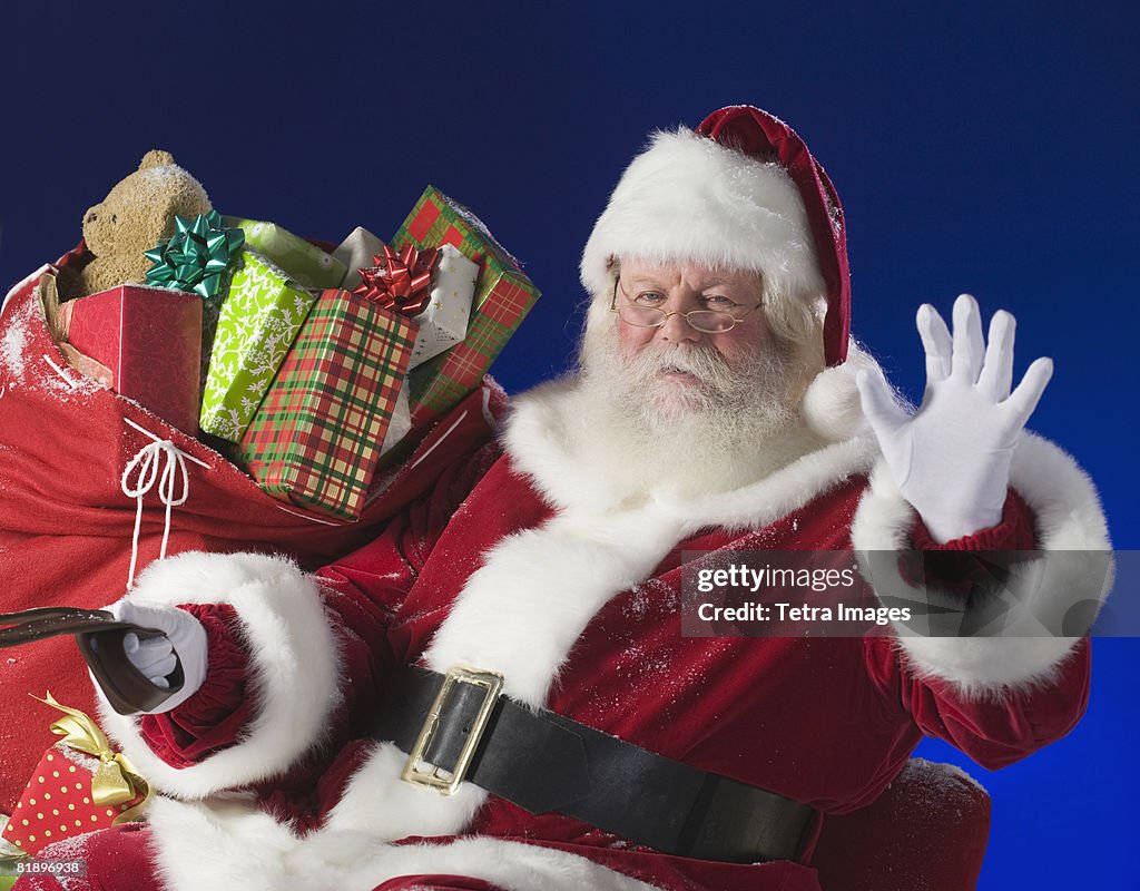 Santa Claus next to bag of toys