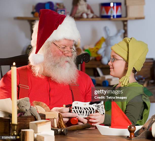 santa claus and elf with toys - elf workshop stock pictures, royalty-free photos & images