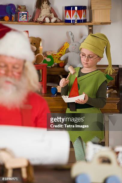 santa claus?s elf making toy - elf workshop stock pictures, royalty-free photos & images