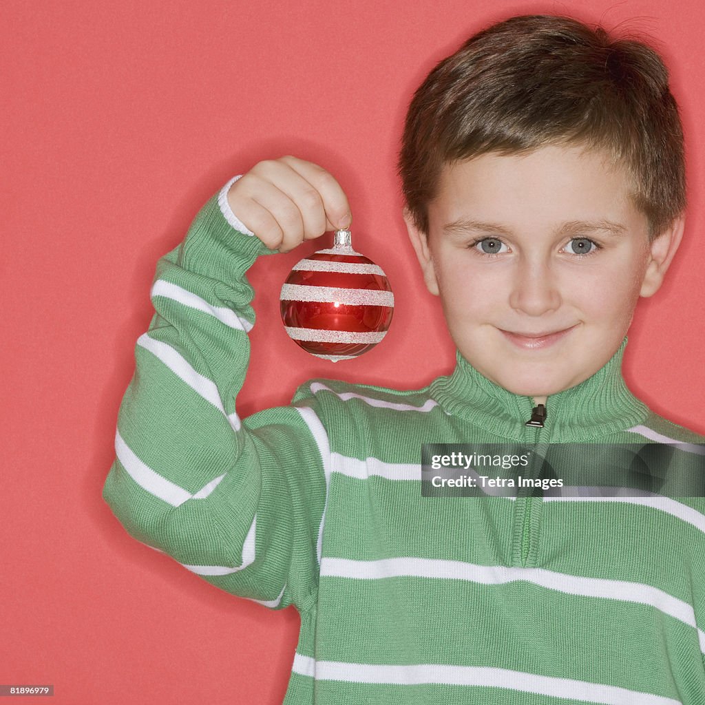 Boy holding Christmas ornament