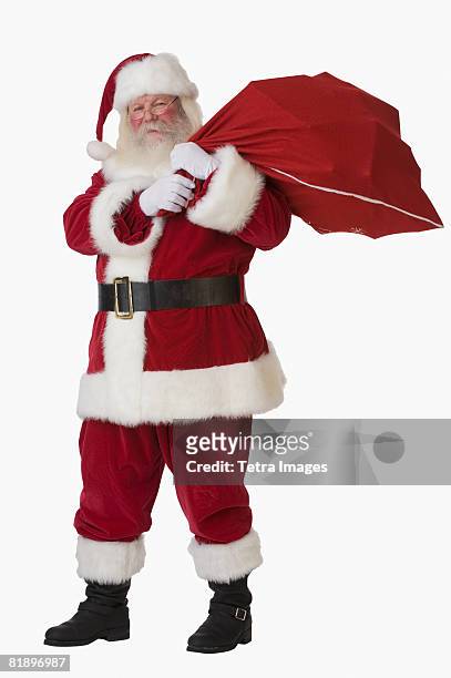 santa claus holding bag of toys - santa giving out presents stock pictures, royalty-free photos & images