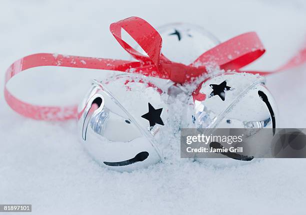 close up of jingle bells in snow - christmas bells stock pictures, royalty-free photos & images