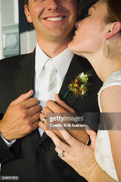 close up of bride kissing groom - bewondering stockfoto's en -beelden